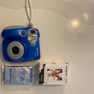 Blue Polaroid 300 Camera with three packs of film